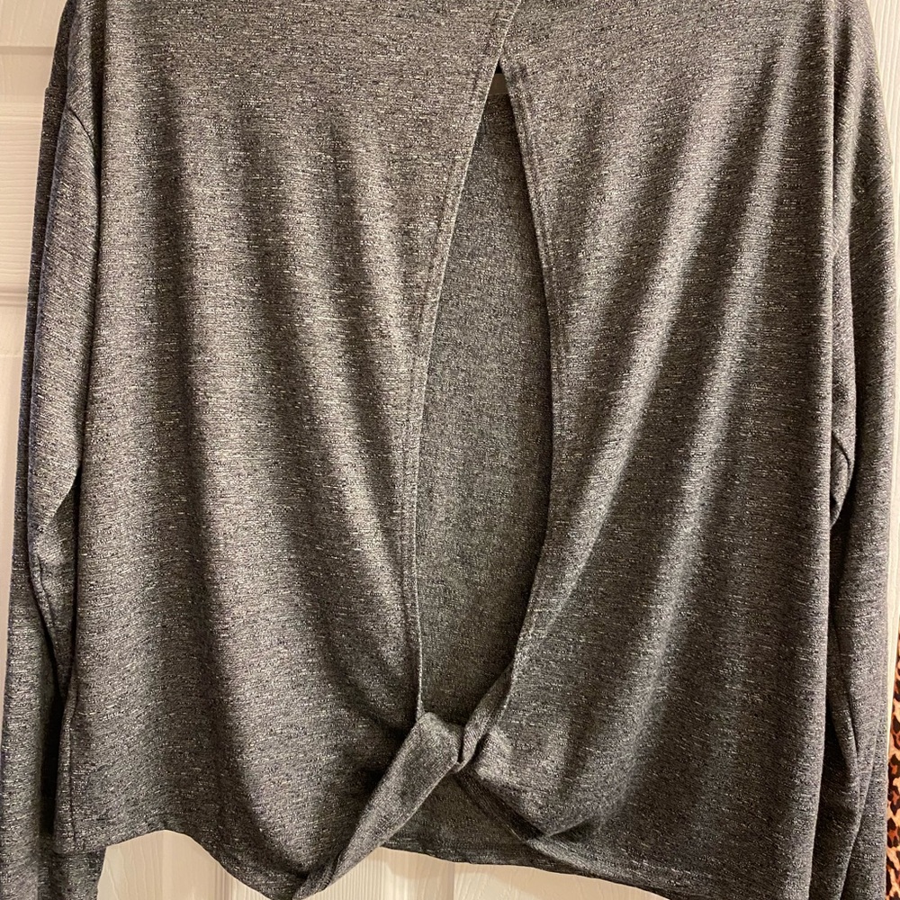 Super cute. Open back. Not long in length but a short top not cropped,